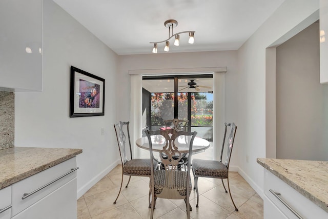 tiled dining space featuring track lighting