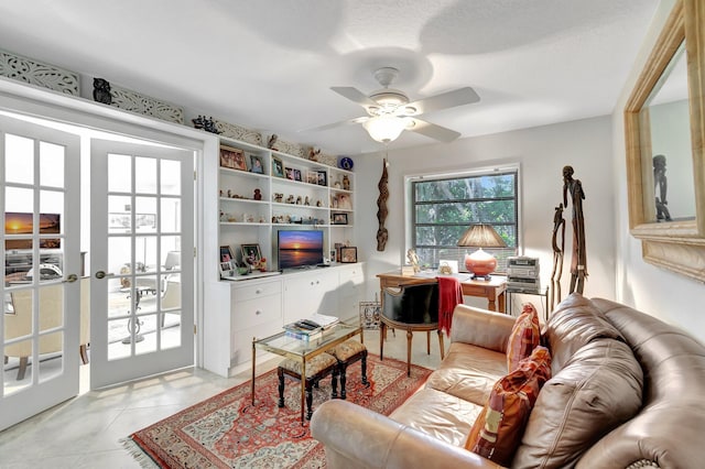 living room featuring ceiling fan and a textured ceiling