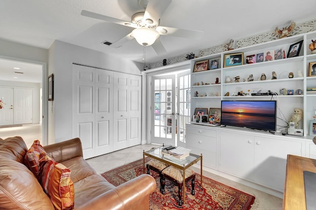 living room with french doors, ceiling fan, and light tile patterned flooring