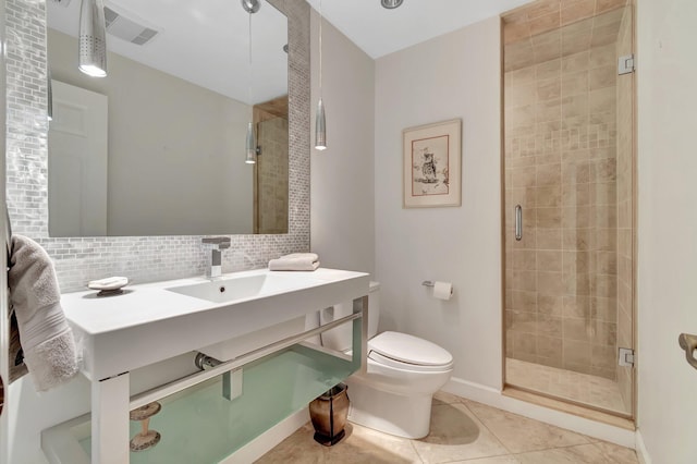 bathroom featuring sink, backsplash, tile patterned floors, an enclosed shower, and toilet