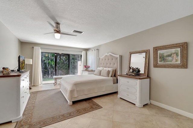 tiled bedroom featuring access to outside, ceiling fan, and a textured ceiling