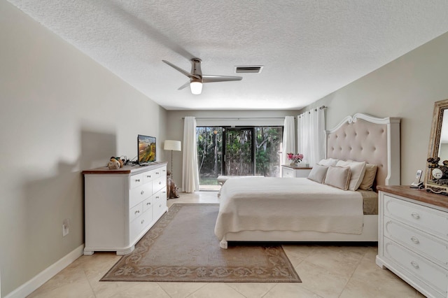 tiled bedroom featuring a textured ceiling, access to outside, and ceiling fan