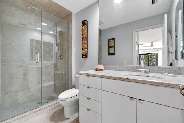 bathroom featuring vanity, tile patterned floors, ceiling fan, toilet, and an enclosed shower