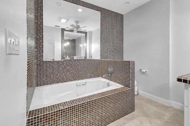 bathroom with tile patterned flooring, ceiling fan, and tiled bath