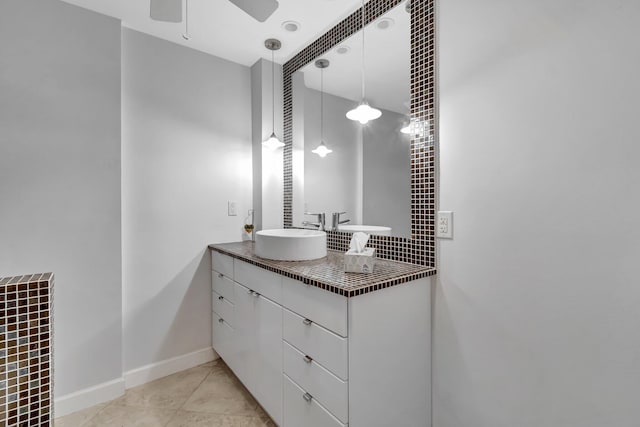 bathroom with tile patterned floors, vanity, and ceiling fan