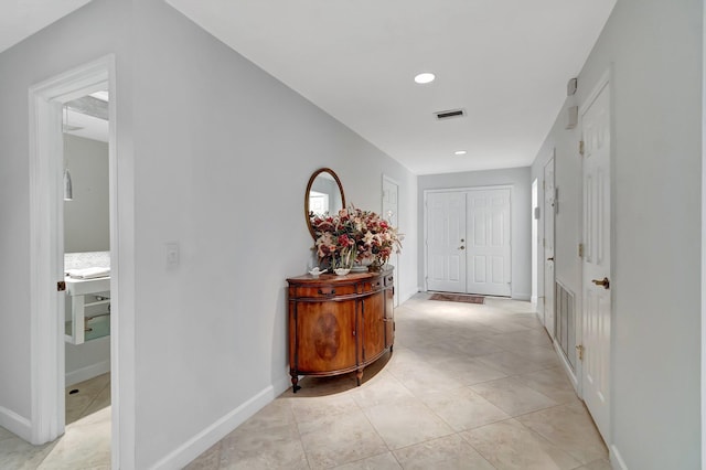 corridor with light tile patterned flooring