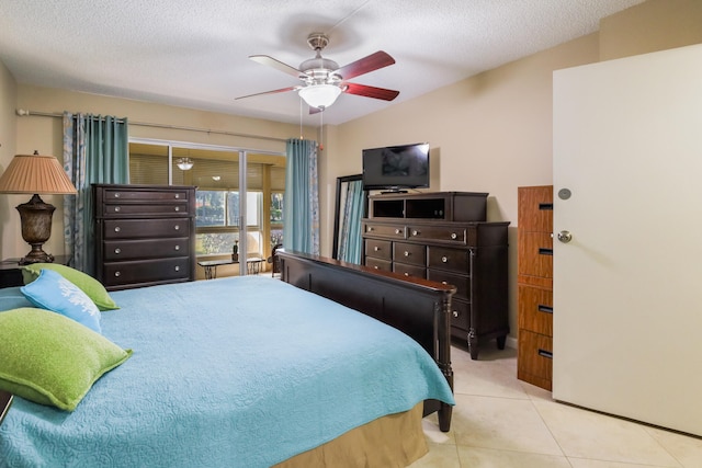 tiled bedroom featuring ceiling fan and a textured ceiling