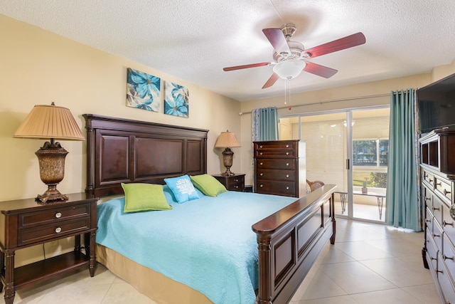 bedroom featuring a textured ceiling, ceiling fan, and light tile patterned flooring