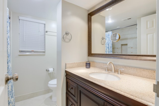 bathroom featuring tile patterned flooring, vanity, toilet, and curtained shower