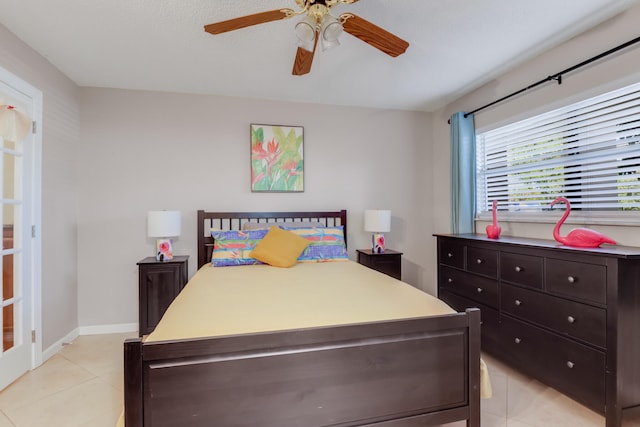 bedroom with light tile patterned floors and ceiling fan