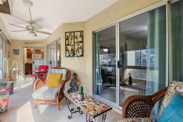 interior space with ceiling fan and light tile patterned flooring