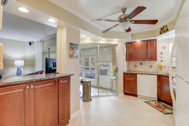 kitchen featuring ceiling fan, dishwasher, light stone counters, crown molding, and decorative backsplash