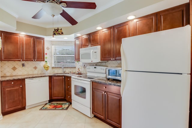 kitchen with decorative backsplash, light stone counters, white appliances, crown molding, and sink