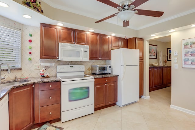 kitchen featuring light stone counters, sink, white appliances, and ornamental molding