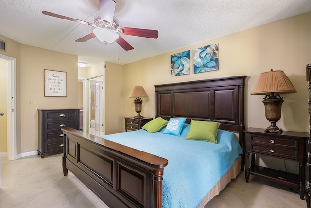 bedroom featuring ceiling fan, a textured ceiling, and connected bathroom