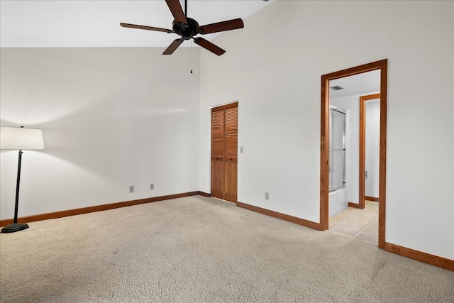 unfurnished bedroom featuring light carpet, ceiling fan, baseboards, and a closet