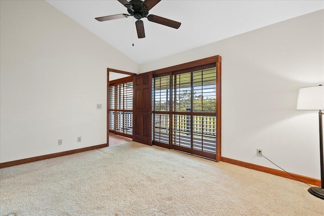 carpeted spare room featuring high vaulted ceiling, ceiling fan, and baseboards