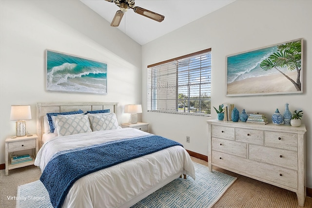 carpeted bedroom with lofted ceiling, a ceiling fan, and baseboards