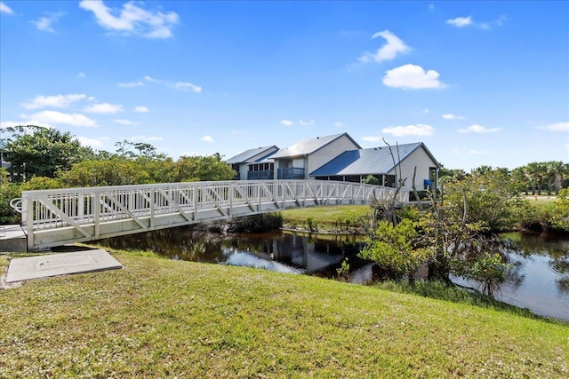 view of dock featuring a water view and a yard