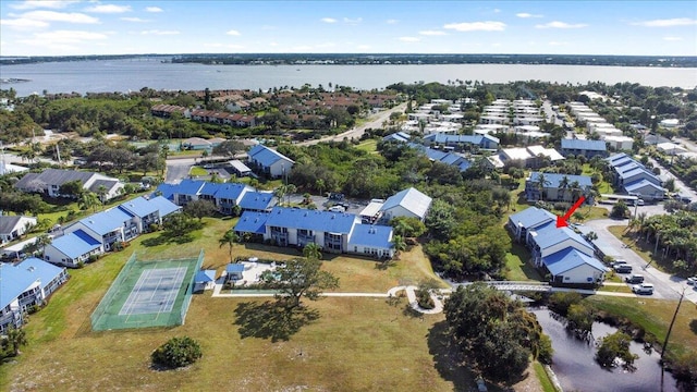 drone / aerial view with a water view and a residential view