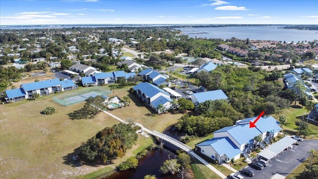 drone / aerial view featuring a water view and a residential view