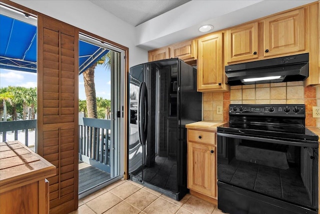 kitchen with light tile patterned floors, light countertops, decorative backsplash, under cabinet range hood, and black appliances