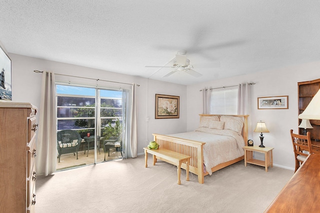 bedroom with a textured ceiling, ceiling fan, light carpet, and access to outside