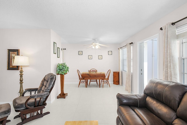 dining space with a textured ceiling and ceiling fan