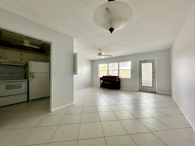 interior space featuring a textured ceiling, ceiling fan, and light tile patterned flooring