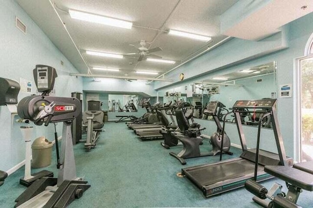 exercise room with plenty of natural light and ceiling fan