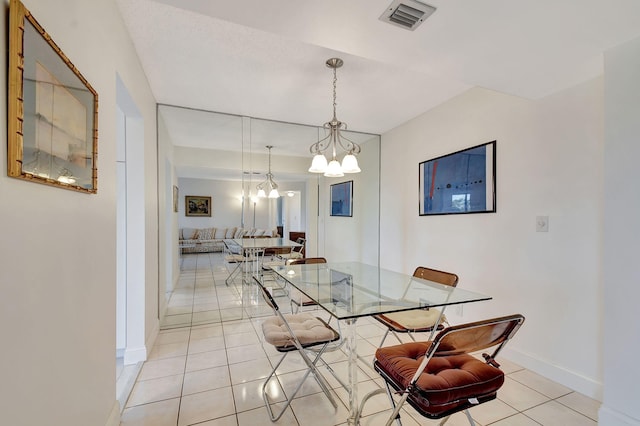 dining room featuring an inviting chandelier and light tile patterned floors