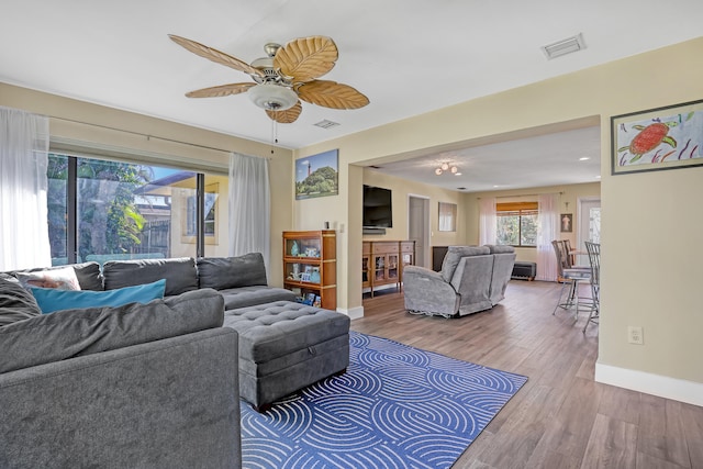 living room featuring ceiling fan and hardwood / wood-style flooring