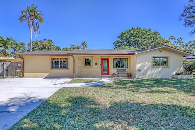 ranch-style home featuring a front yard