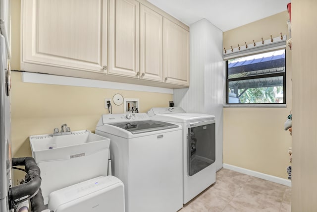 washroom featuring cabinets, separate washer and dryer, and sink