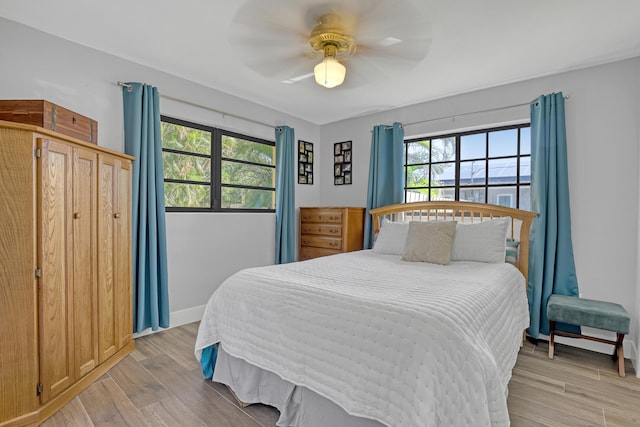 bedroom featuring ceiling fan and light hardwood / wood-style floors