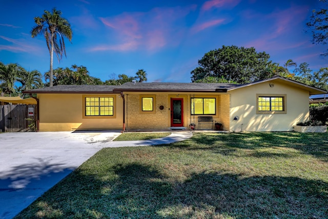 ranch-style home with a yard