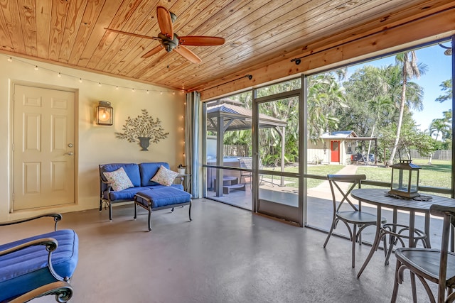 sunroom featuring ceiling fan and wood ceiling