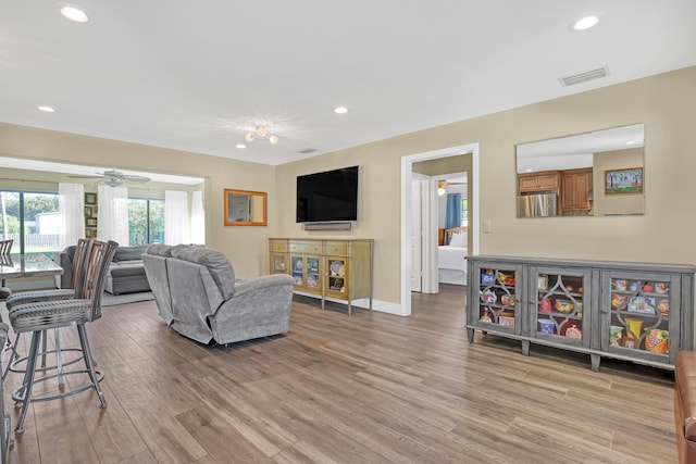 living room featuring ceiling fan and hardwood / wood-style floors