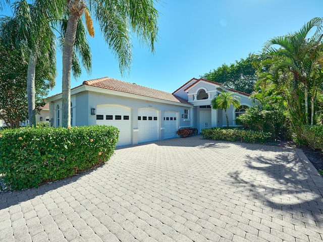 mediterranean / spanish home featuring a garage