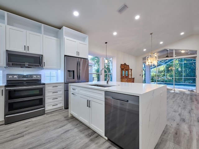 kitchen with pendant lighting, sink, white cabinetry, and stainless steel appliances