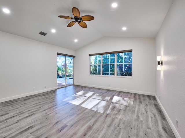 empty room featuring ceiling fan, light hardwood / wood-style floors, and vaulted ceiling