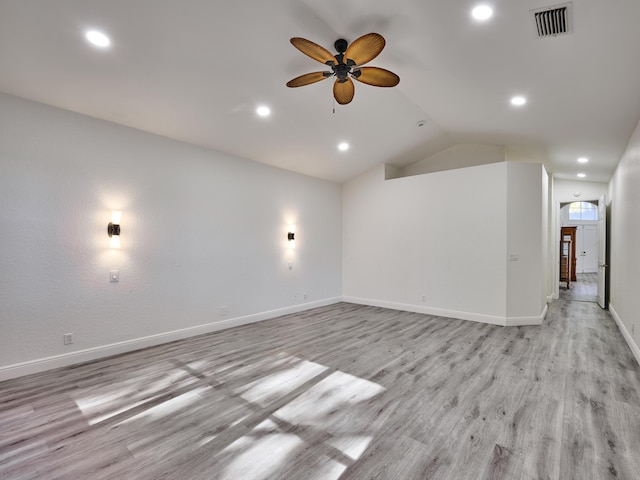 unfurnished room with ceiling fan, light hardwood / wood-style flooring, and vaulted ceiling