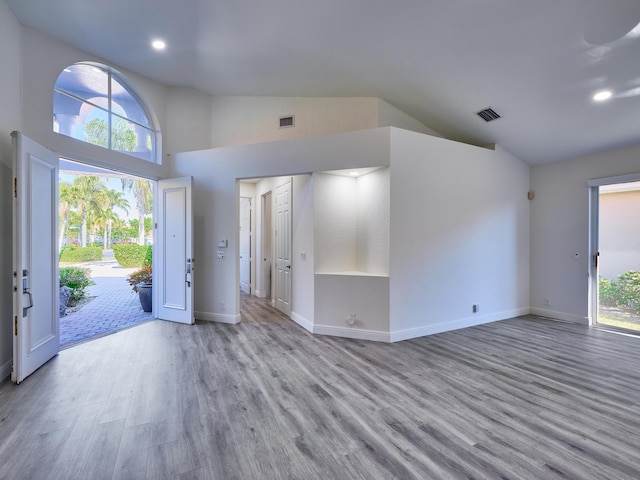 entrance foyer featuring light hardwood / wood-style floors and high vaulted ceiling