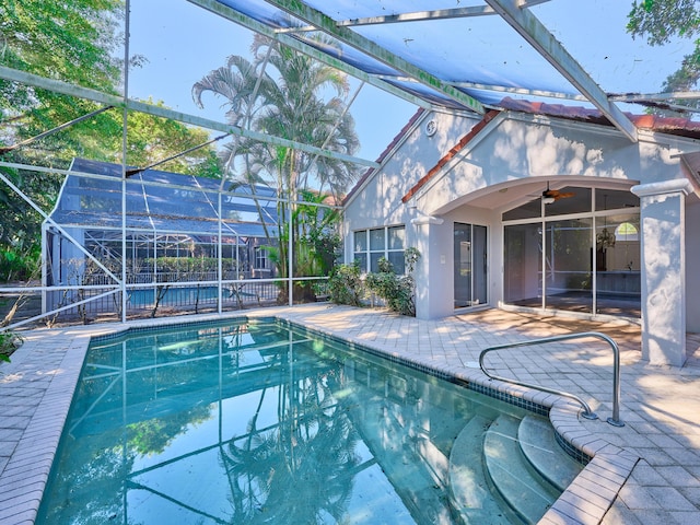 view of pool featuring ceiling fan, a lanai, and a patio