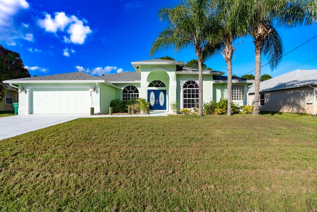 view of front of house with a front yard and a garage