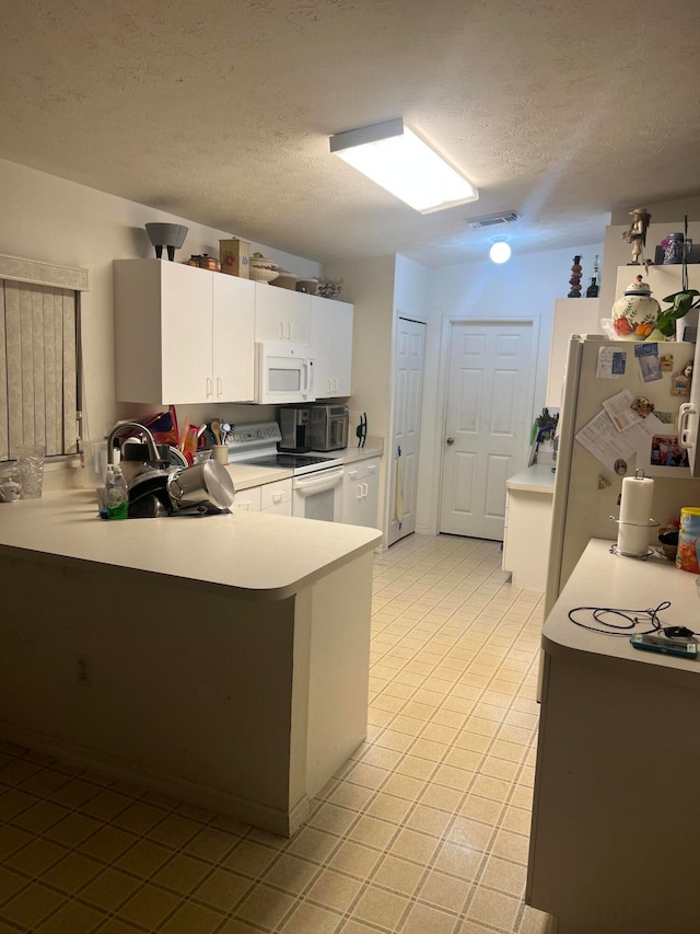 kitchen featuring white appliances, sink, kitchen peninsula, a textured ceiling, and white cabinetry