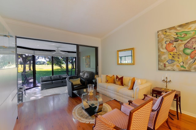 living room with crown molding, ceiling fan, vaulted ceiling, and hardwood / wood-style flooring