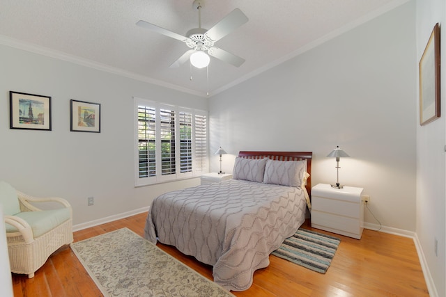 bedroom with ceiling fan, light hardwood / wood-style floors, and crown molding