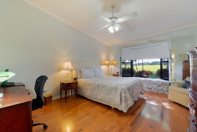 bedroom with hardwood / wood-style flooring, ceiling fan, and crown molding