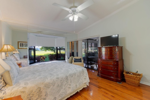 bedroom featuring ceiling fan, hardwood / wood-style floors, crown molding, and vaulted ceiling